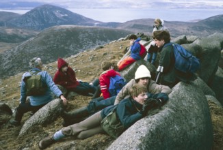 Lunch break for a group of boys during geographical fieldwork in the mountains of the Isle of