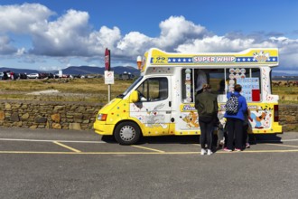 Tourists at the ice cream van, ice cream car, ice cream cones for sale at the roadside, spring