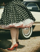 Vintage American road cruiser Buick with woman and petticoat