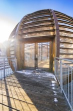 Close-up of an entrance to the wooden ball with decorative incidence of light and shadows, forest