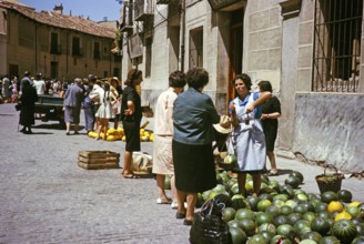 Selling watermelons and honeydew melons at the street market, Segovia, Castilla y León, Spain 1964