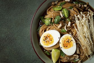 Soba, buckwheat noodles, with enoki mushrooms, shimeji and boiled egg, top view, homemade, no