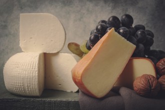 Georgian cheese, Imeretian and smoked suluguni, grapes, nuts, on a cutting board, Georgian cuisine,