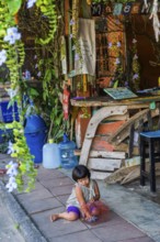 Child playing in a street scene in the old town of Ko Lanta, ramshackle, city, urban, live, living,