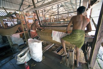 Indian workers in the weaving mill of the Labourers Coir Mats and Mattings Cooperation, coir mat