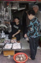 Stall selling duck giblets, including dried duck blood, an inexpensive foodstuff that is very