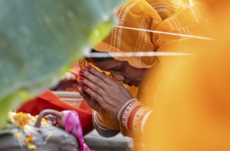 Hindu devotees perform rituals as they offer prayers to the Sun god in the bank of Brahmaputra