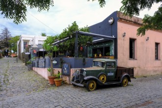 Colonia del Sacramento, Colonia, Uruguay, vintage cars parked in the alleyways of the old town.