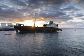 Lost Place, Ghost Ship, A huge shipwreck in the calm waters with a stunning sunset in the