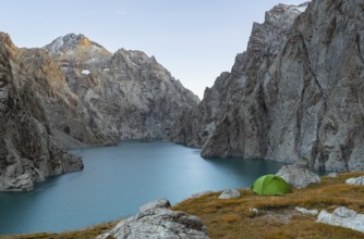 Wild camping, camping in the wilderness with a tent in front of mountain lake Kol Suu, Sary Beles