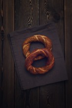 Traditional Turkish bagel Simit, Top view on a wooden table, vertical, no people, rustic style