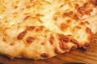 Imereti khachapuri, Traditional Georgian dish, flatbread with cheese, top view, no people, rustic