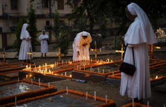 Nuns offer prayers on the grave during the All souls day observation, in Guwahati, India on 2