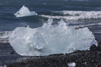 Little icebergs and crushed ice on the black beach at Joekulsarlon glacial lake