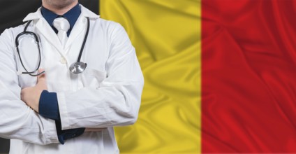 Male doctor with stethoscope on Belgium flag. Doctor holding stethoscope on Belgium flag