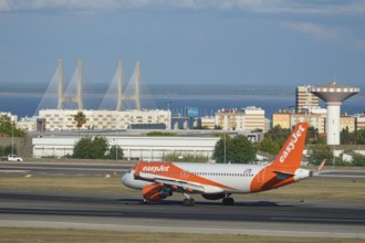 Lisbon, Portugal - September 2, 2023: easyJet Airbus A320-214 passenger plane taxi on runway in