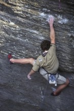 Rock climber climbing in sandstone cliff Wanterbaach, Berdorf, Little Switzerland / Mullerthal,