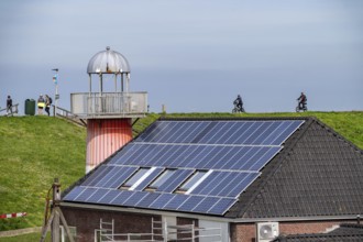 Solar modules on roofs, on the roof of a building on the dyke, North Sea coast, in Zeeland,