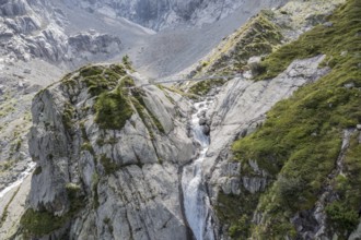 Aerial view, hikers at bridge over glacial stream, large single rock, hiking path from La Fouly to