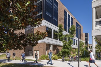 Students walk past the Brooks College of Health building at the University of North Florida in