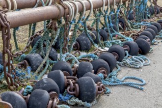 Spools and floats for bottom trawling with a trawl, drying on a road, Büsum, Schleswig-Holstein,