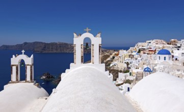 Bell towers in Oìa with a view of the caldera, Oía, Santorini, Cyclades, Greece, Europe