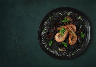 Black pasta with seafood, spaghetti with shrimp and mussels, top view, homemade, no people