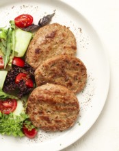 Fried cutlets, minced beef, with vegetable salad, top view, no people