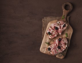 Breakfast, bacon and olives sandwich, on a cutting board, top view, close-up, no people