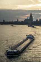 The Rhine near Cologne, sunset, Cologne Cathedral, cargo ship, North Rhine-Westphalia, Germany,