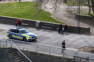 Effects of the coronavirus crisis, empty shopping street, police patrol car, Rhine bank