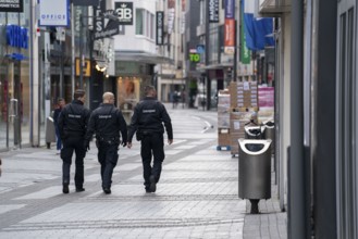 Effects of the coronavirus crisis, empty shopping street, patrol from the public order office,