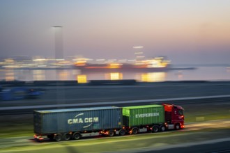 Lorry on the road from Euromax Terminal Rotterdam, ENECO wind farm on the dike around the port of