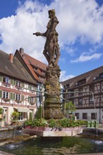 Knights on the market fountain, a tubular fountain with half-timbered houses in Gengenbach, Black