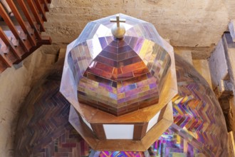 Colourful church dome with stained glass and a cross, geometric patterns and bright colours,