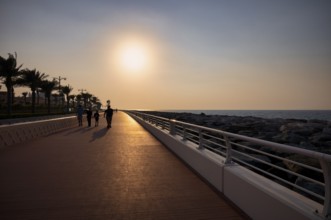 Sunset, walker, The Boardwalk, waterfront promenade, Palm Jumeirah, Dubai, United Arab Emirates,