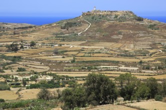 Rural landscape view from Zebbug to hilltop Ta 'Gurdan, Gordan or Gordon lighthouse, Gozo, Malta,