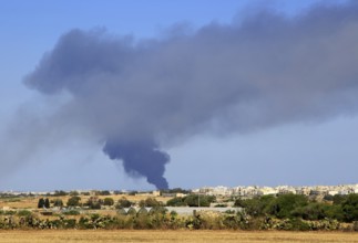 Smoke clouds atmospheric pollution from large fire at recycling centre, Malta, 22 May 2017, Europe