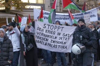 Demonstrators with banner Stop the war in Gaza, peace between Israel and Palestine, Pro Palestine