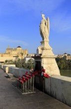 Angel San Rafael statue on Roman bridge with views cathedral, Cordoba, Spain, Europe