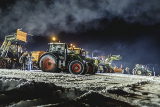 Tractors during a rally as part of the farmers' protests on the snow-covered Kirchbichl,