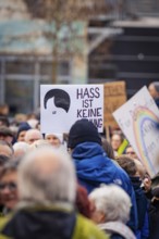 Sign with the message HATE IS NOT AN OPINION in the middle of a blurred crowd, demonstration