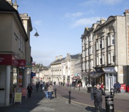 Shops and shoppers in the High Street of the town of Chippenham, Wiltshire, England, United