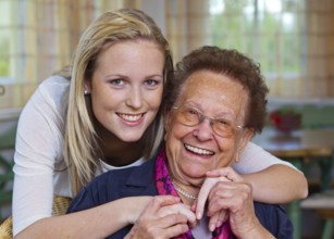 A grandson visits his grandmother Fun and joy while hugging, Vienna, Austria, Europe