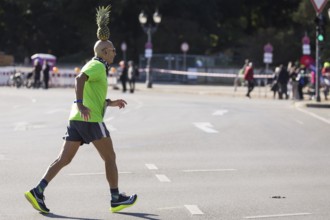 Pineapple Marathon Runner (Moshe Lederfien) balances a pineapple on his head during the run at the