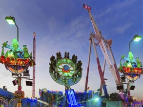 People on the illuminated carousel Mr Gravity in the evening, Cranger Kirmes, Herne, Ruhr area,