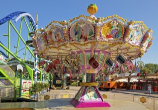 Empty children's carousel under a blue sky in the morning, Cranger Kirmes, Herne, Ruhr area, North