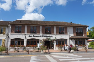 Cosy French restaurant with floral decorations and outdoor terrace on a sunny day, Épine, Epine,