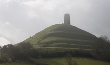 Contre jour view of St Michael's Tower on Glastonbury Tor, Somerset, England, United Kingdom,