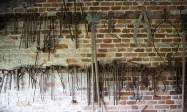 Old rusty farming tools at Helmingham Hall, Suffolk, England, United Kingdom, Europe